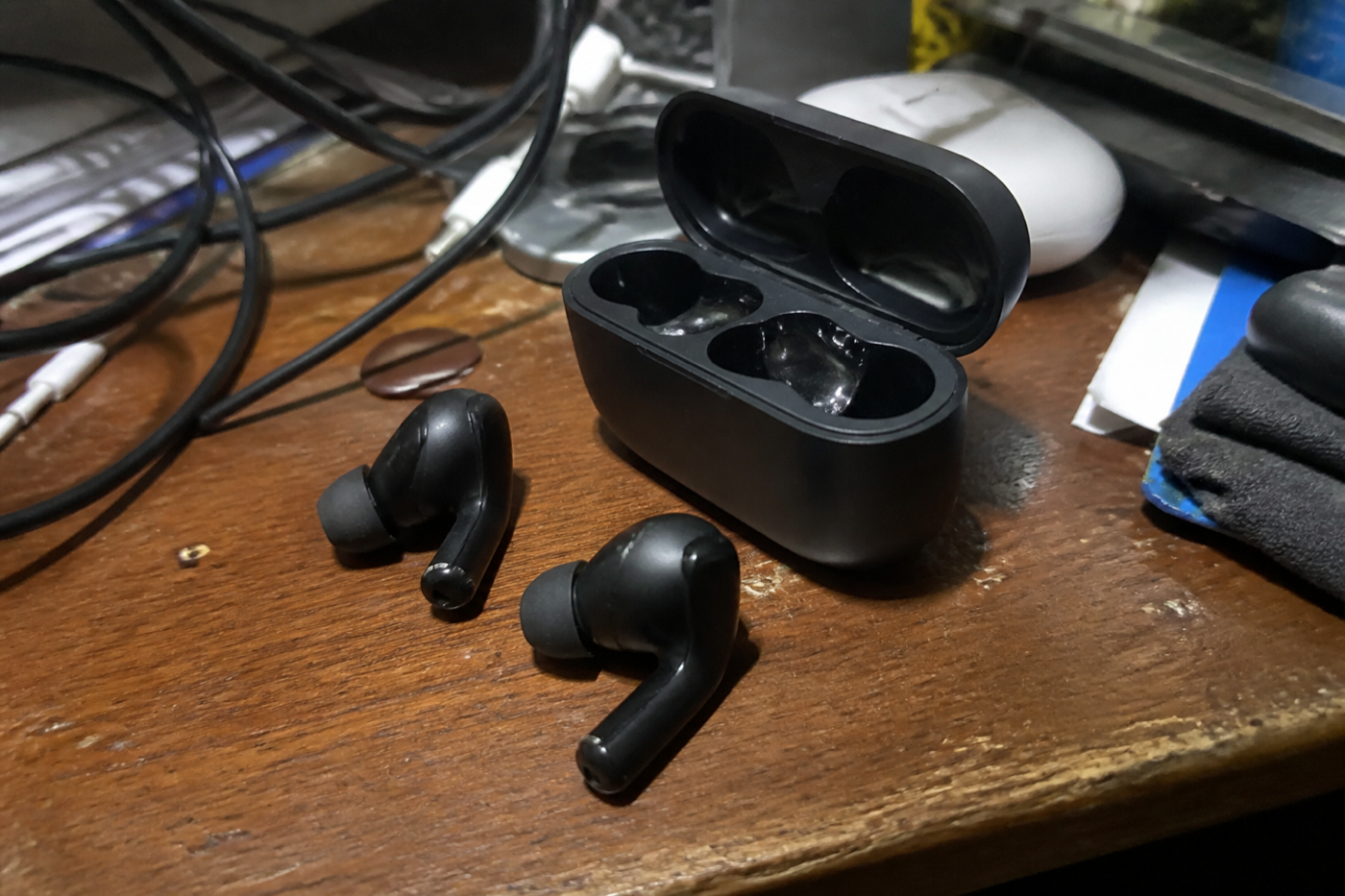 Earbuds on a messy desk
